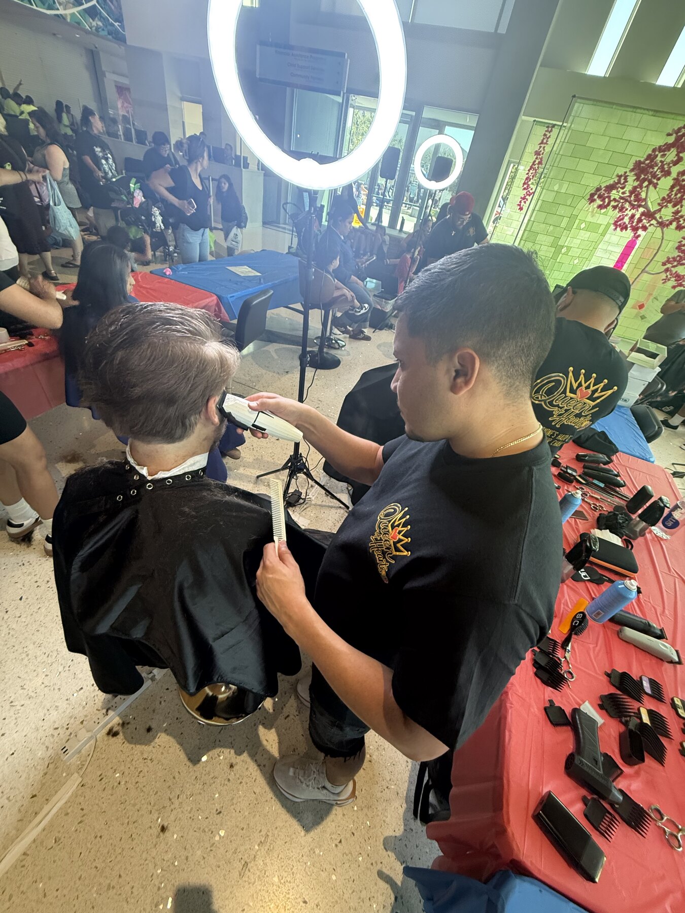 Queen of Hearts barber giving a haircut at the Adams County event